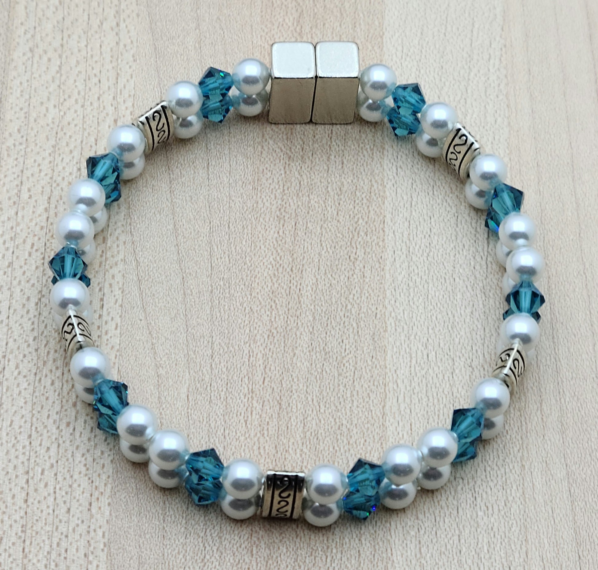 Soft & SO pretty define this double row bracelet of pale moonlight crystal pearls & light teal crystals. The fancy dividers are lead & nickel free alloy.
Neodymium magnetic clasp - these are awesome . . . & VERY strong!