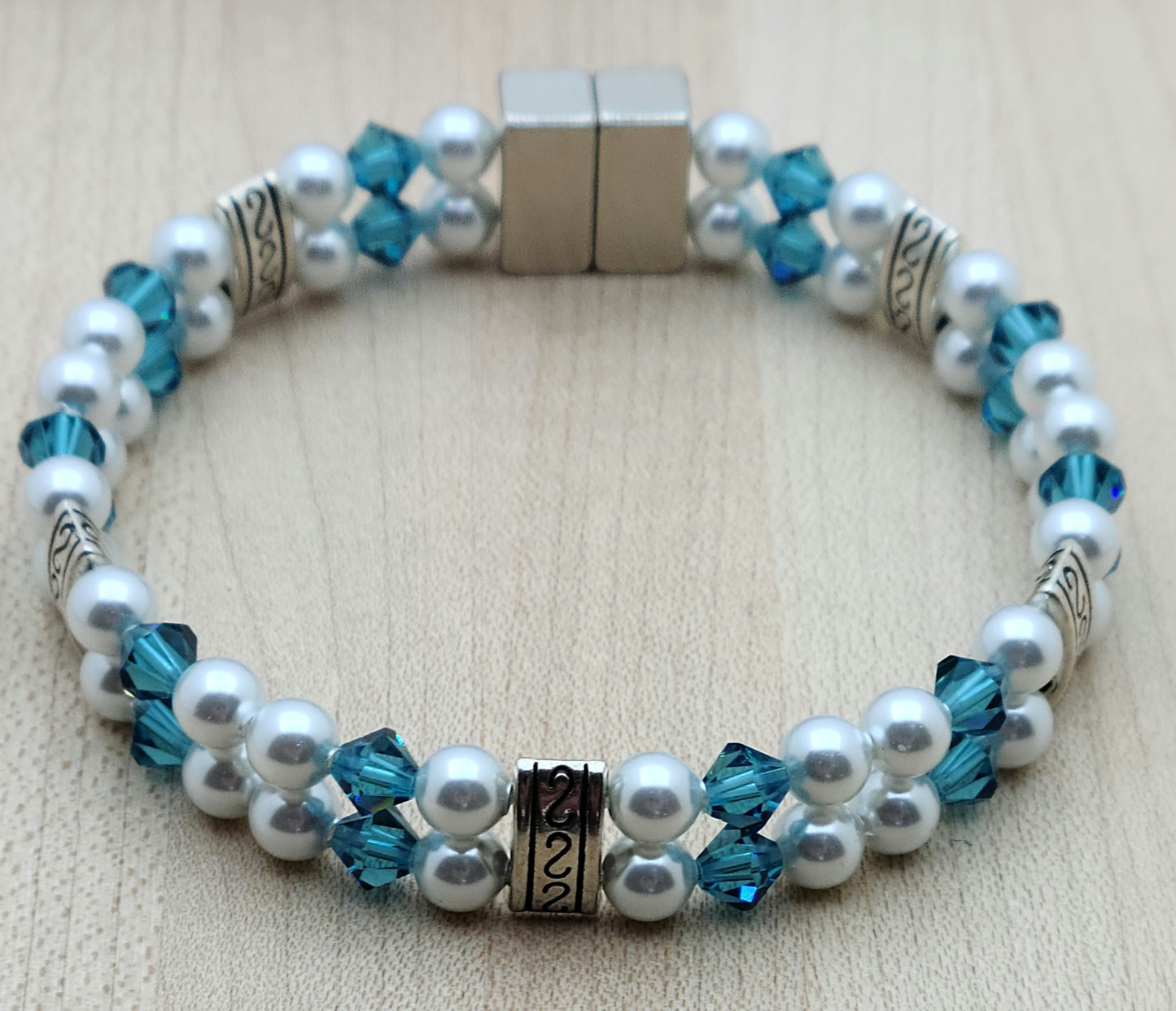 Soft & SO pretty define this double row bracelet of pale moonlight crystal pearls & light teal crystals. The fancy dividers are lead & nickel free alloy.
Neodymium magnetic clasp - these are awesome . . . & VERY strong!