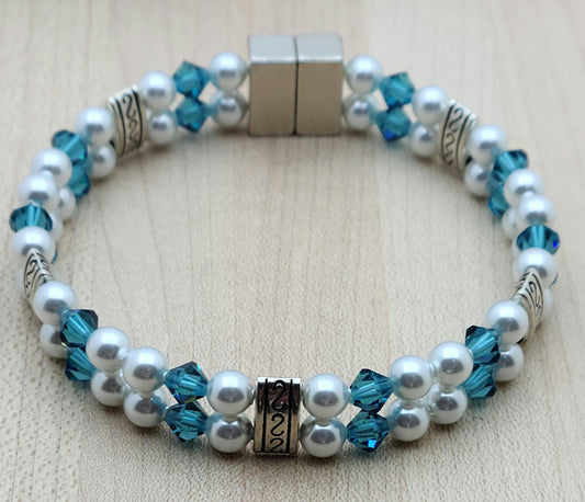 Soft & SO pretty define this double row bracelet of pale moonlight crystal pearls & light teal crystals. The fancy dividers are lead & nickel free alloy.
Neodymium magnetic clasp - these are awesome . . . & VERY strong!