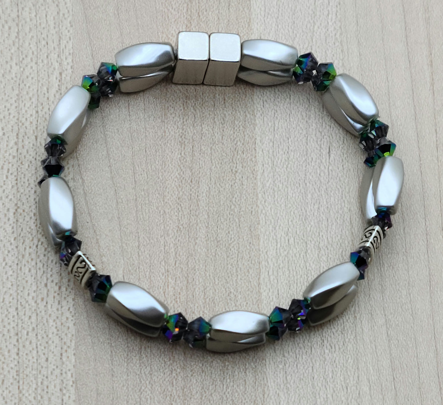 The metallic, almost iridescent greens, blues, & purples of the scarab beetle come to life in the fascinating crystals of the magnetic hematite bracelet. The fancy dividers are lead & nickel free alloy.
Neodymium magnetic clasp - these are awesome . . . & VERY strong!