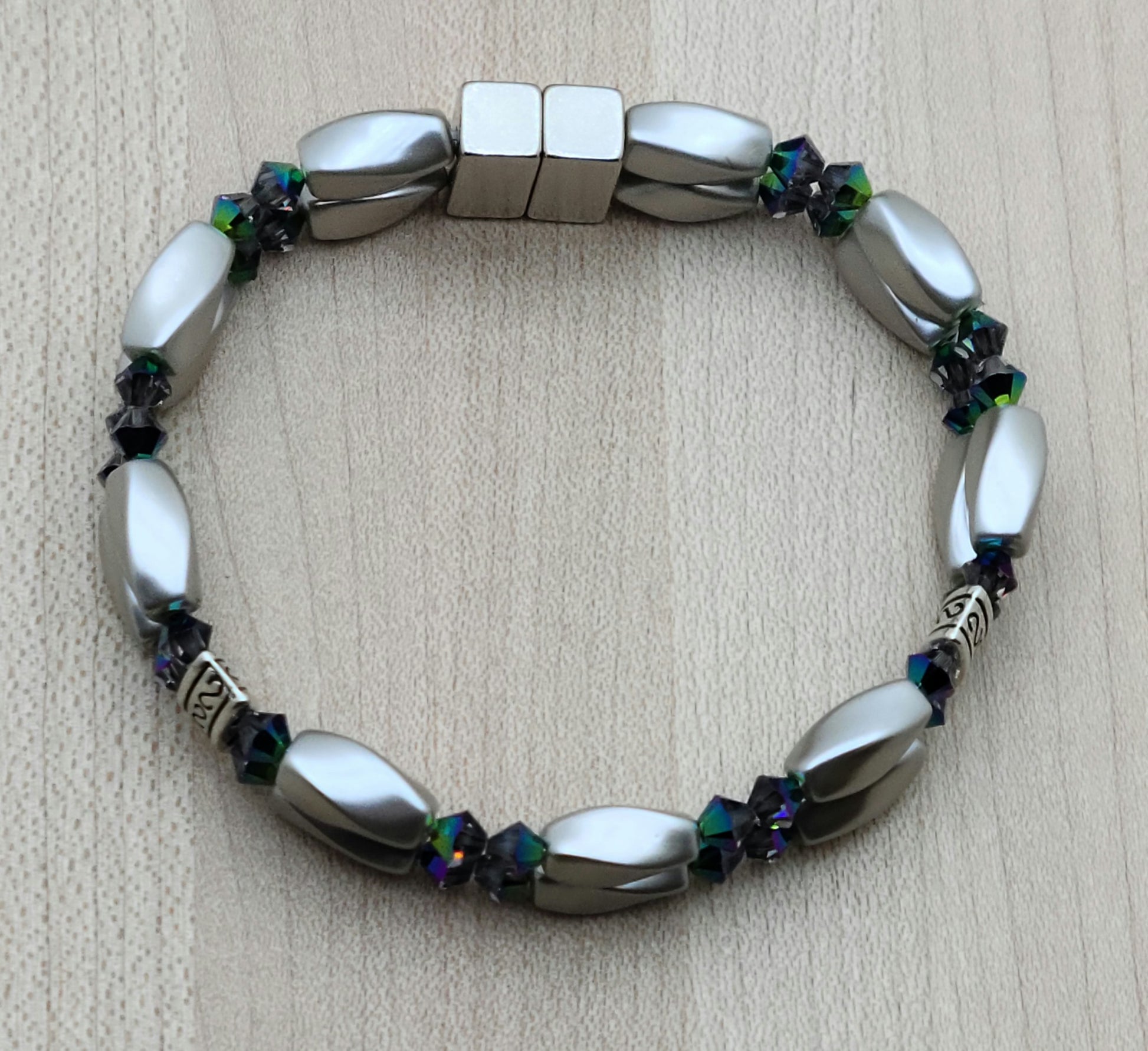 The metallic, almost iridescent greens, blues, & purples of the scarab beetle come to life in the fascinating crystals of the magnetic hematite bracelet. The fancy dividers are lead & nickel free alloy.
Neodymium magnetic clasp - these are awesome . . . & VERY strong!