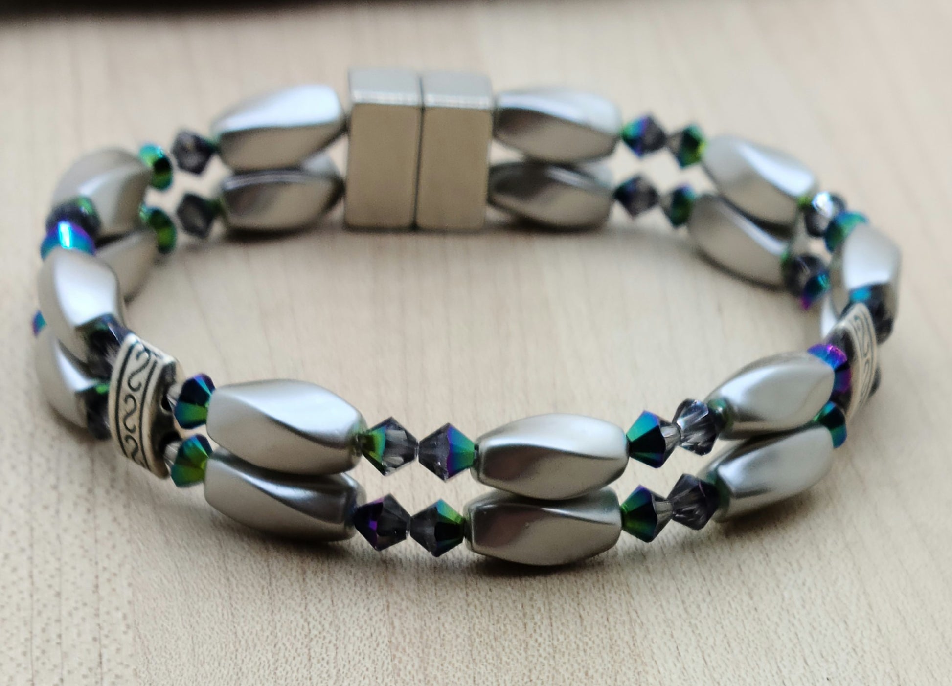 The metallic, almost iridescent greens, blues, & purples of the scarab beetle come to life in the fascinating crystals of the magnetic hematite bracelet. The fancy dividers are lead & nickel free alloy.
Neodymium magnetic clasp - these are awesome . . . & VERY strong!