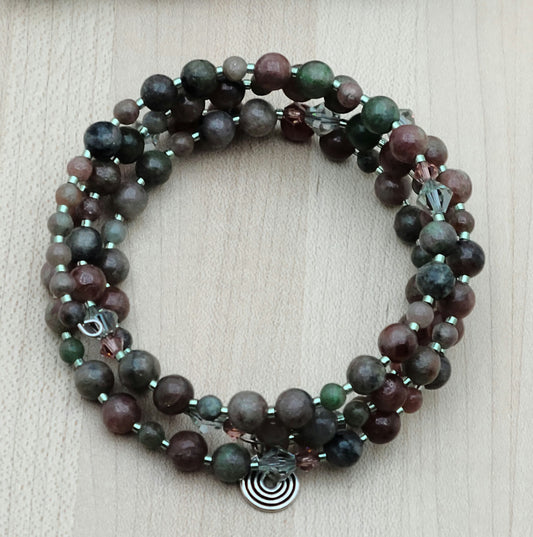 The mixed, earthy color palette of burgundy, forest green, black, & white swirls in Kashgar garnet are paired with pale green & vintage rose crystals & green Miyuki delica to create a lovely 4 row memory wire bracelet.