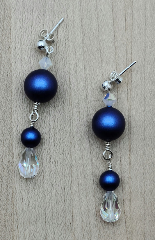 You can't help but love the deep, iridescent blue crystal pearls in these earrings that are terminated with crystal teardrops! 2" with sterling silver ball post stud earrings