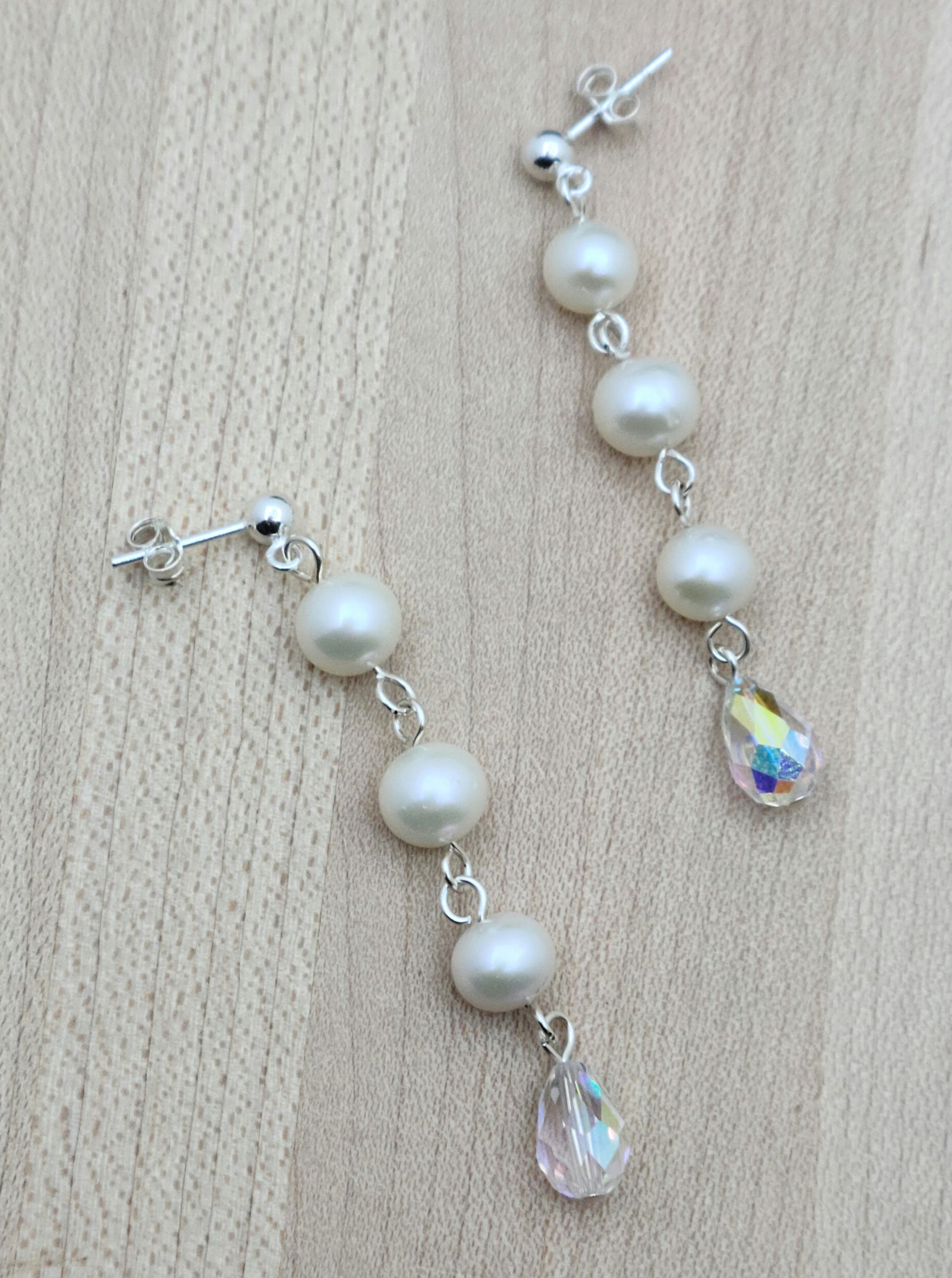 Freshwater pearls are SO classy. You'll love the movement and sparkle of this pair that joins pearls &amp; aurora borealis teardrop crystals! 2" with sterling silver ball post earrings