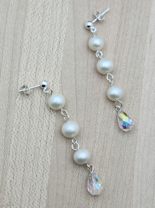 Freshwater pearls are SO classy. You'll love the movement and sparkle of this pair that joins pearls &amp; aurora borealis teardrop crystals! 2" with sterling silver ball post earrings