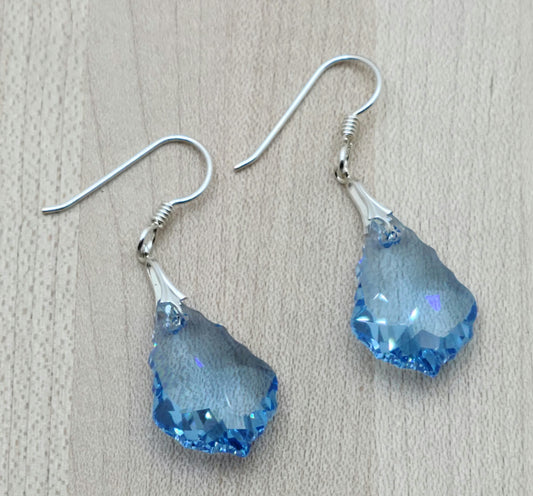 These baroque shaped crystal earrings are a gorgeous shade of aquamarine!
1 7/8" with sterling silver bails & fish hook ear wires.