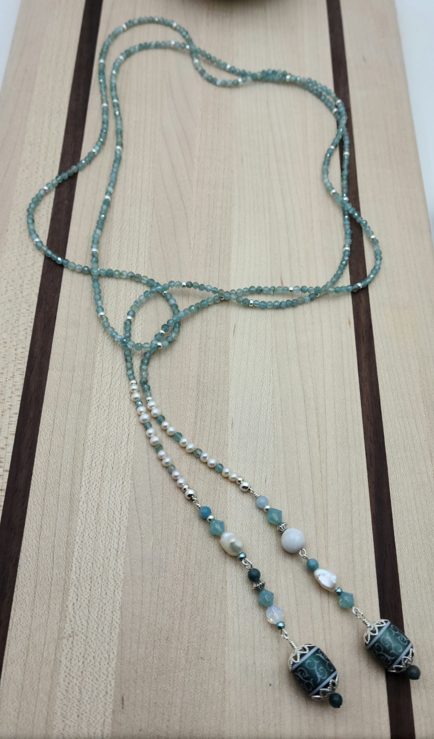 Be your own stylist with this versatile lariat necklace of tiny, light reflecting faceted aqua apatite beads & featuring lovely etched crystal focals.
You have apatite, crystals*, Miyuki (the best brand) seed beads, FW pearls, aquamarine, &amp; white crazy lace. SO much to see in 57"!