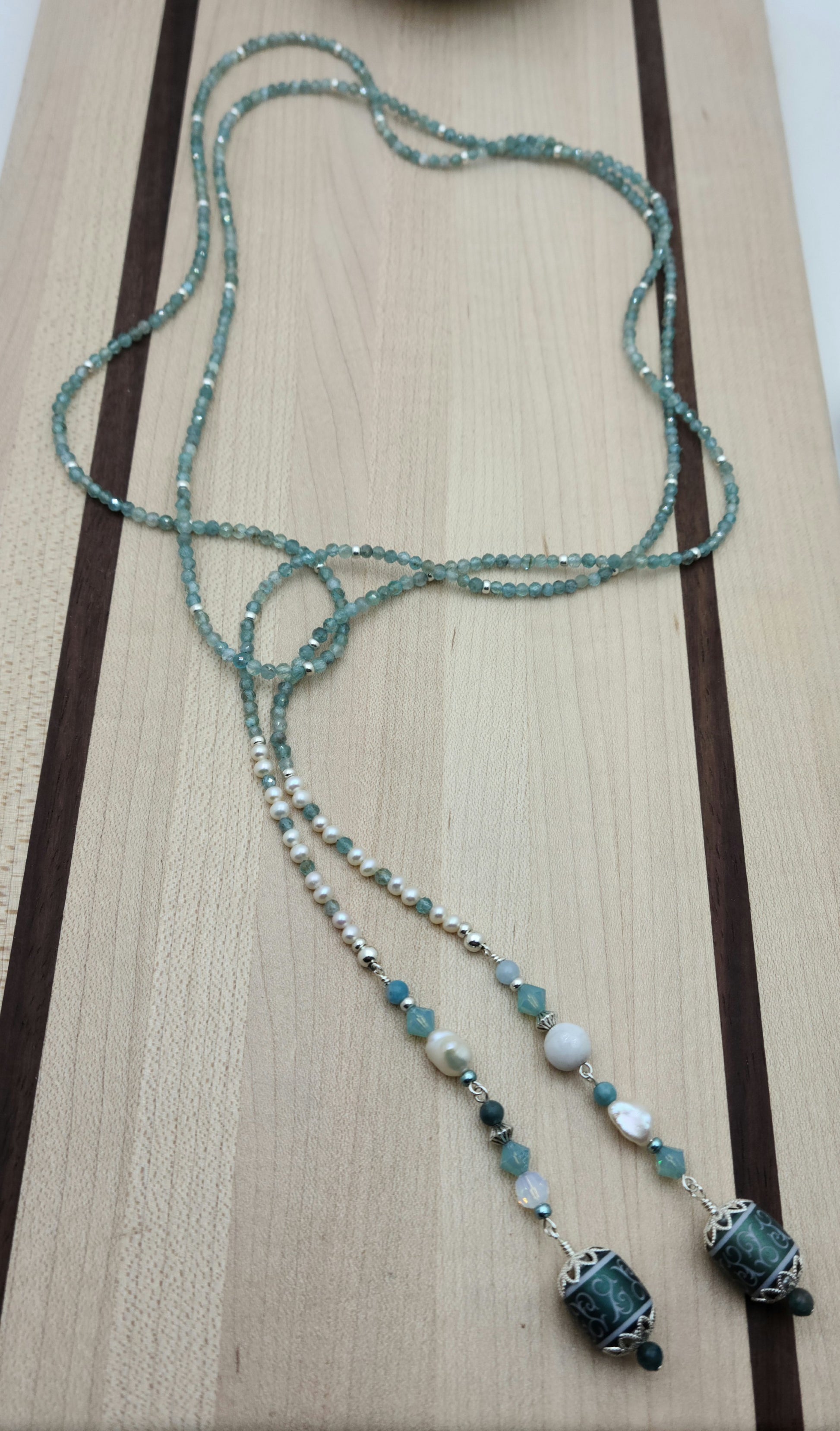 Be your own stylist with this versatile lariat necklace of tiny, light reflecting faceted aqua apatite beads & featuring lovely etched crystal focals.
You have apatite, crystals*, Miyuki (the best brand) seed beads, FW pearls, aquamarine, &amp; white crazy lace. SO much to see in 57"!