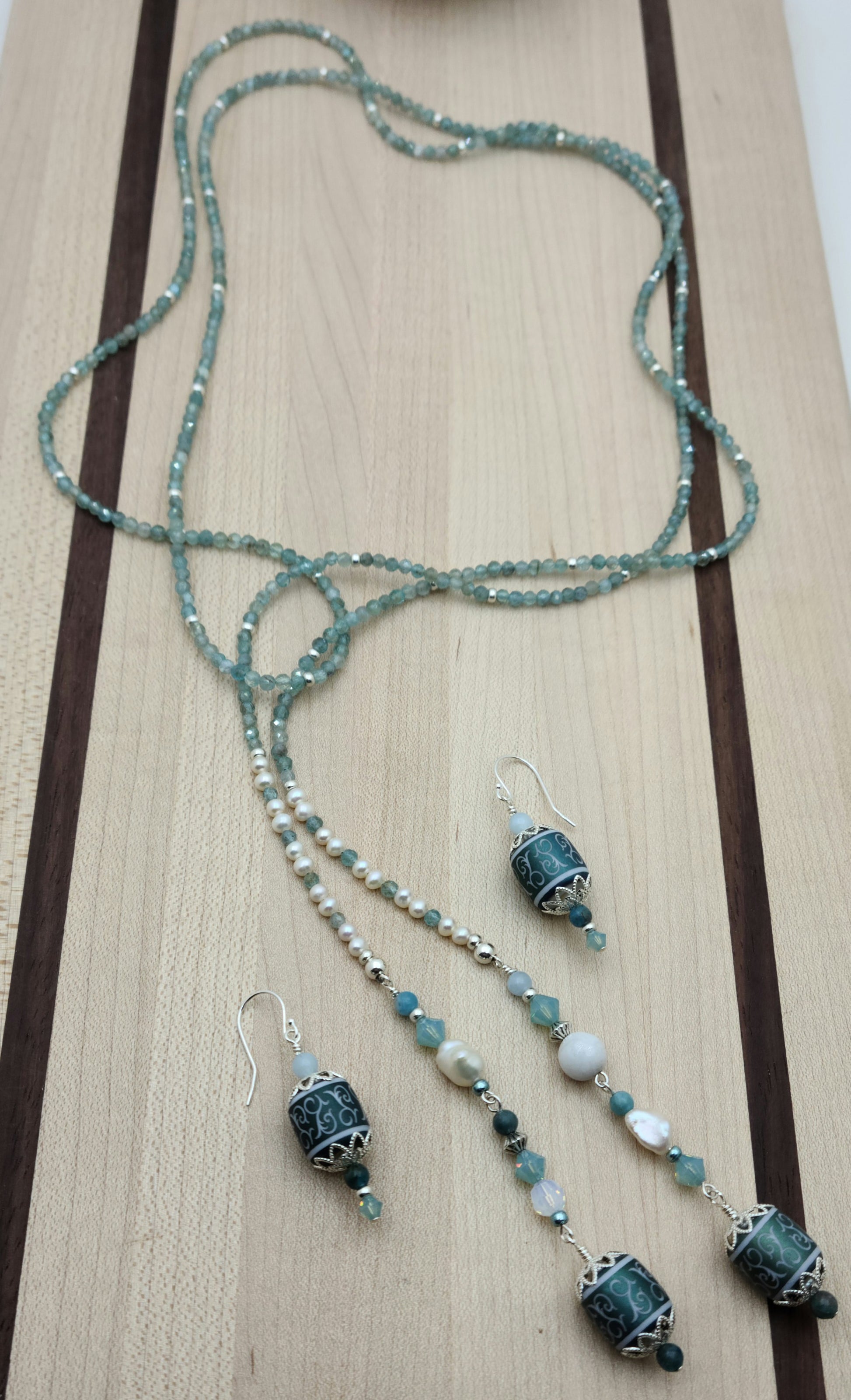 Be your own stylist with this versatile lariat necklace of tiny, light reflecting faceted aqua apatite beads & featuring lovely etched crystal focals.
You have apatite, crystals*, Miyuki (the best brand) seed beads, FW pearls, aquamarine, &amp; white crazy lace. SO much to see in 57"! 2" etched crystal earrings.