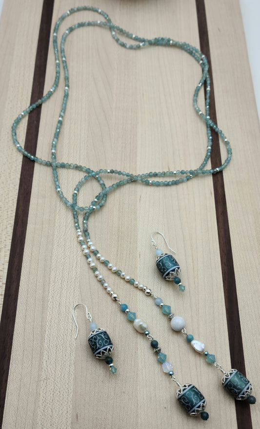 Be your own stylist with this versatile lariat necklace of tiny, light reflecting faceted aqua apatite beads & featuring lovely etched crystal focals.
You have apatite, crystals*, Miyuki (the best brand) seed beads, FW pearls, aquamarine, &amp; white crazy lace. SO much to see in 57"! 2" etched crystal earrings.