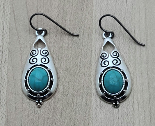 These stamped, lead-free pewter earrings are adorned with turquoise howlite and are extremely lightweight. A great look without the weight! niobium (hypoallergenic) fish hook ear wires