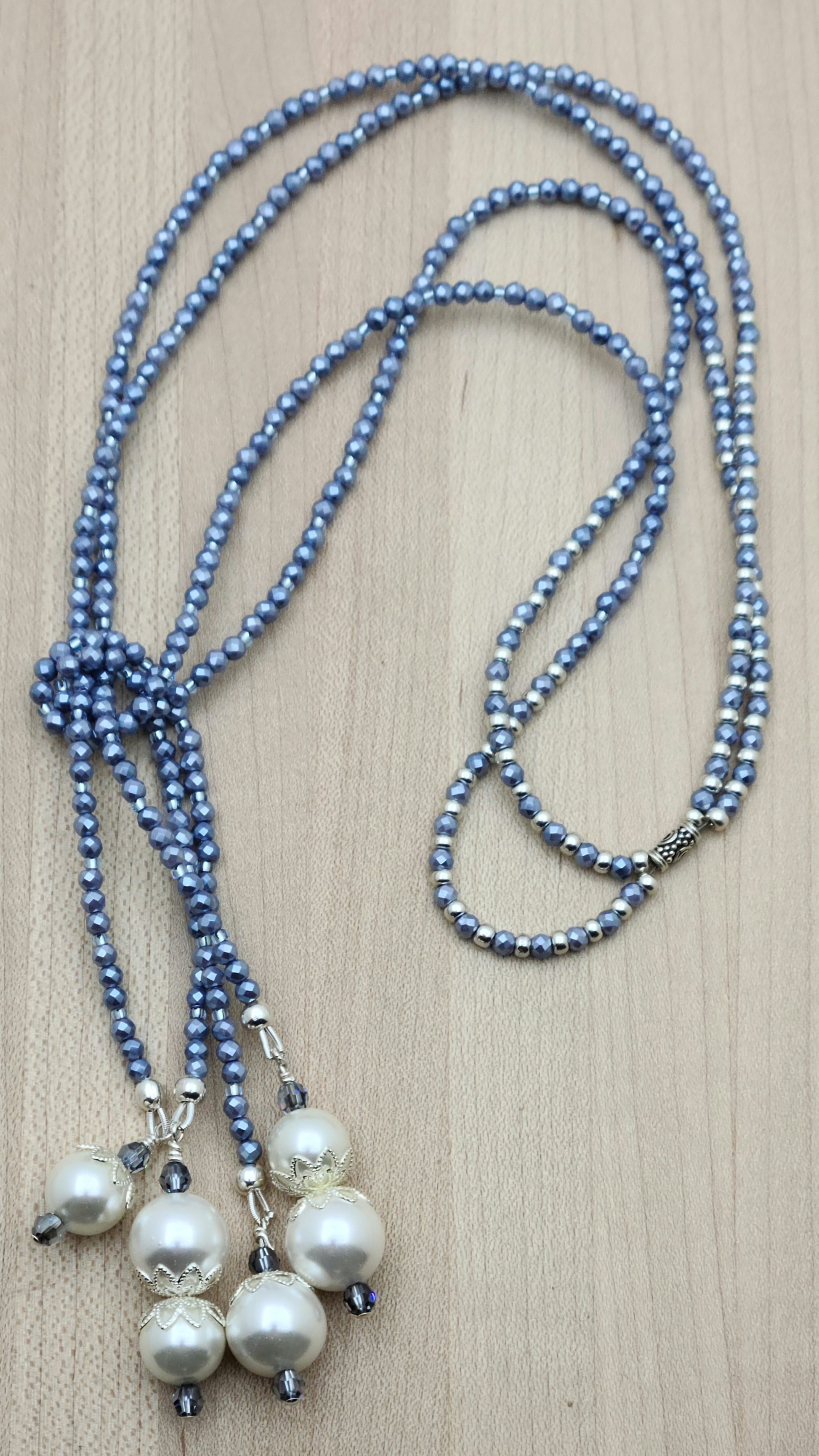 You'll turn heads with this elegant & sparkling lariat of tiny sky blue shell pearls, large white shell pearls, &am sapphire crystals
