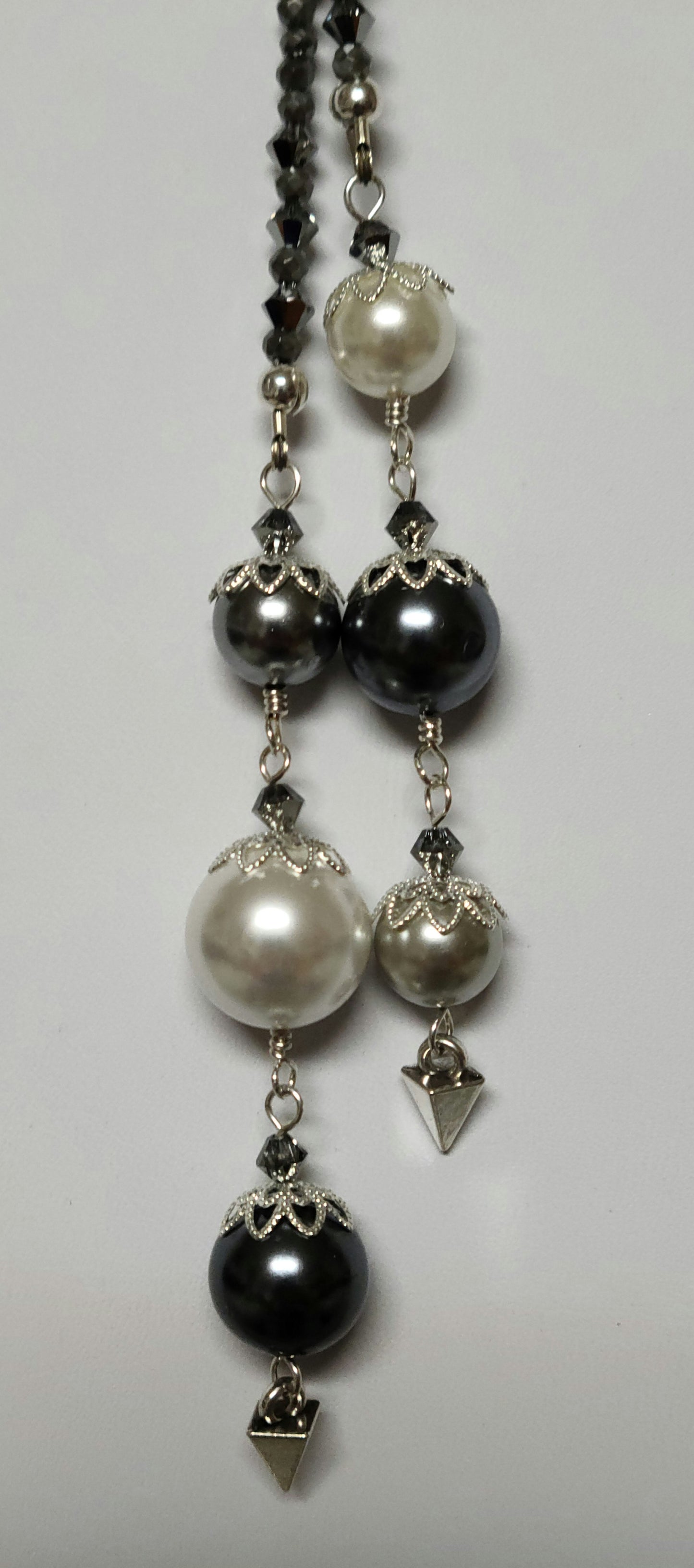 close up of shell pearls on ends of lariat