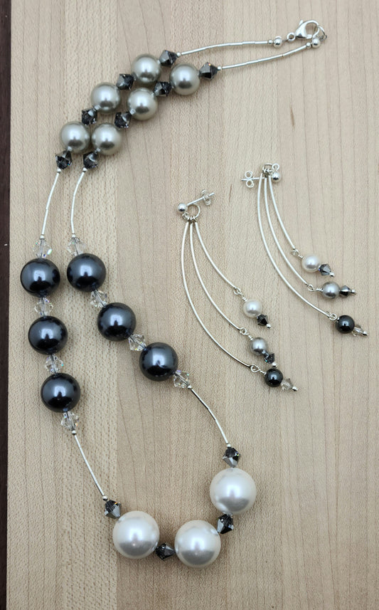 Large light silver, dark silver, and white shell pearls shine alongside liquid silver accents and sparkling crystals in this elegant matching set. Crystal pearl, crystal, hematite, & sterling silver earrings - curved bars on ball post
