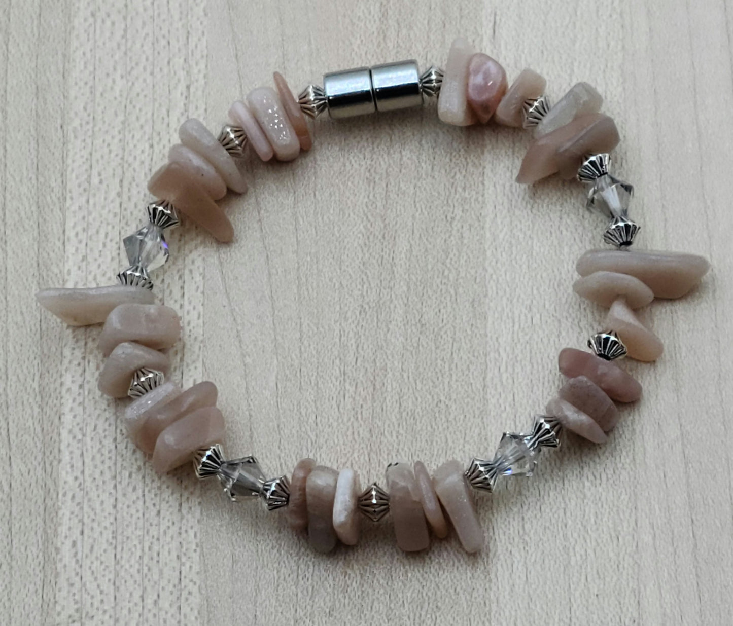 The soft look of peach moonstone nuggets is enhanced with crystals* and pewter beads to create a lovely bracelet. Has magnet closure.