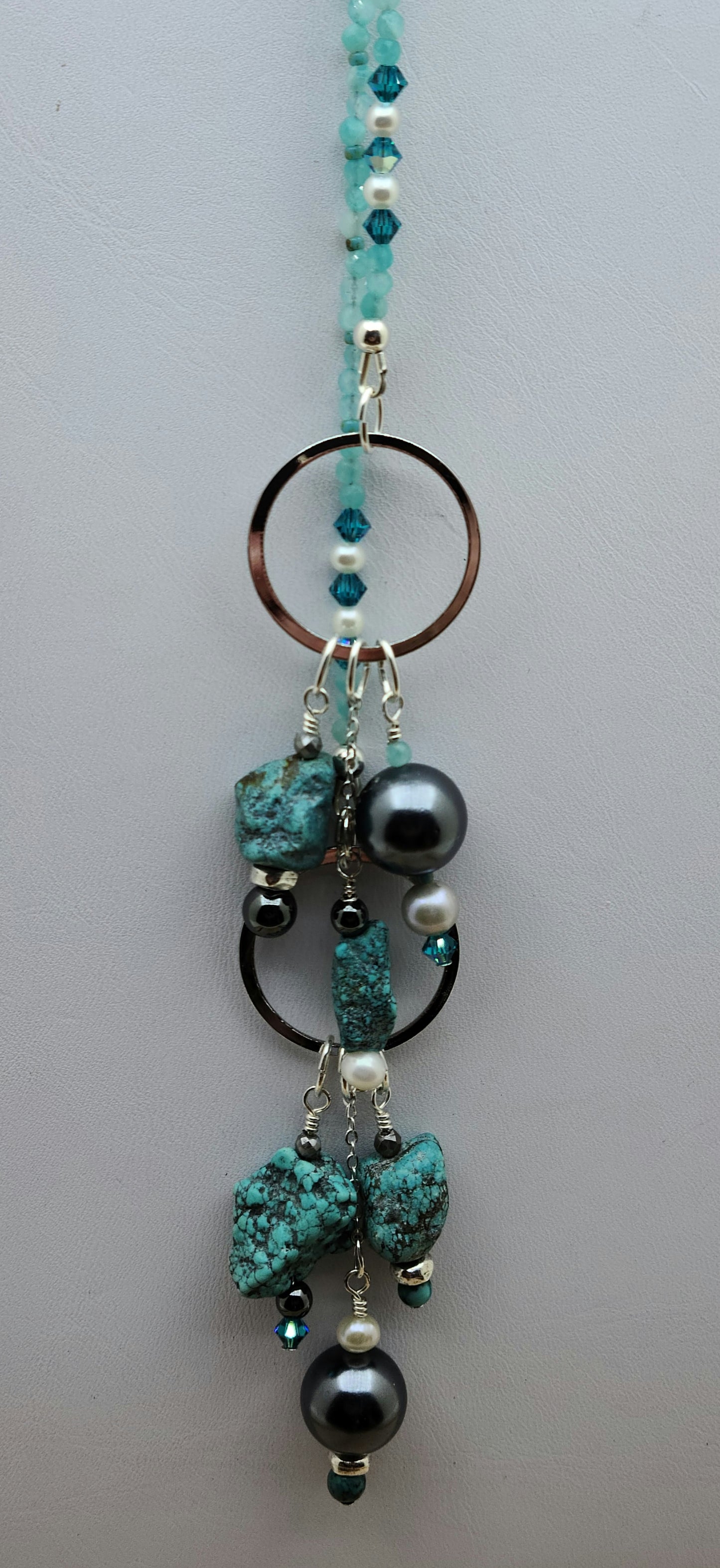 Lariat style necklace of shell pearls, fw pearls, hematite, crystals, turquoise, & amazonite. 