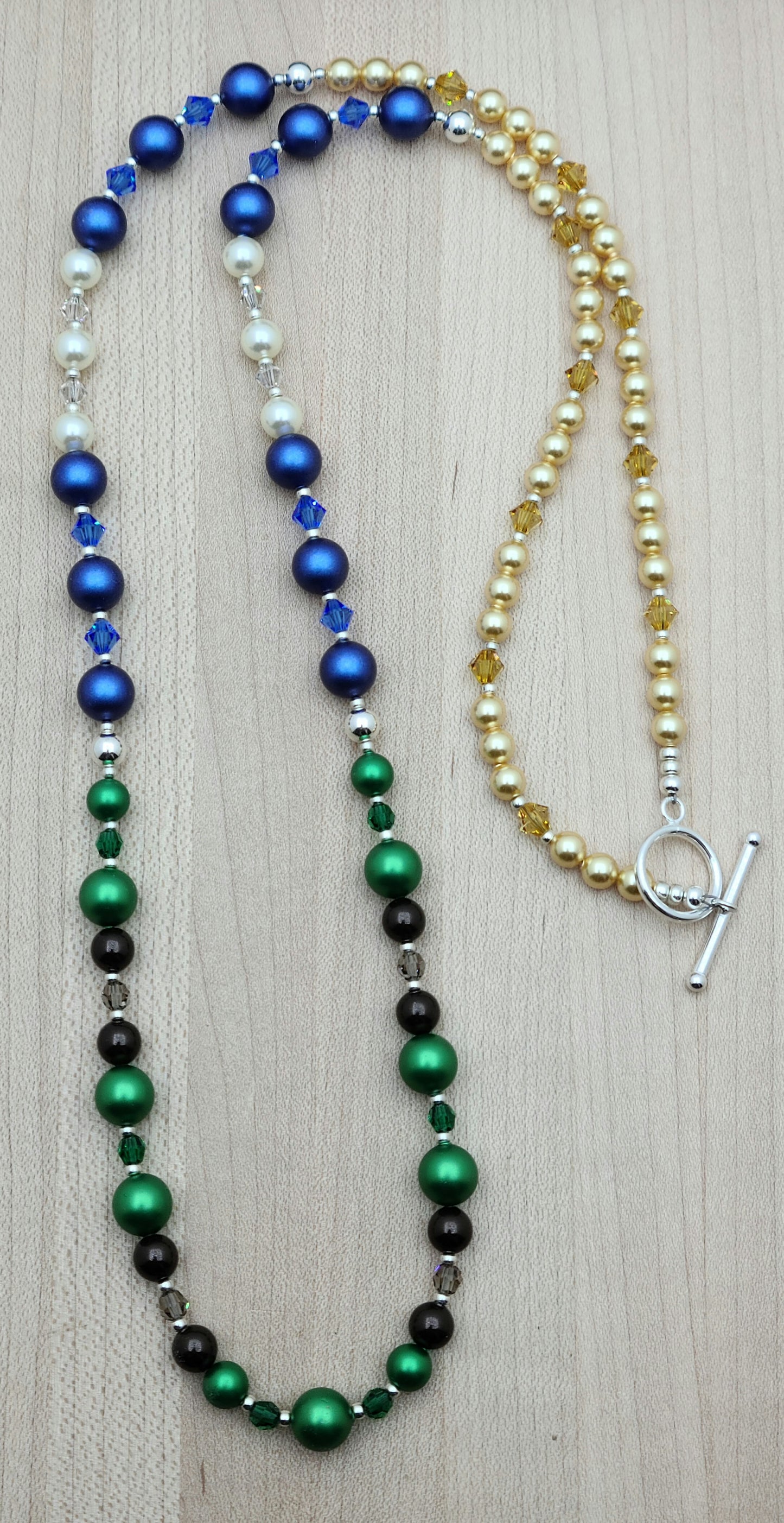 Nature lovers rejoice. This necklace has it all - earth, growth, water. clouds, sky, & sun! All represented by bright crystal pearls and crystals.