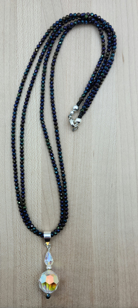 You'll be drawn to the shimmery aurora borealis coating of these tiny black spinel stones and that shimmer continues in the aurora borealis coating of the crystal pendant.