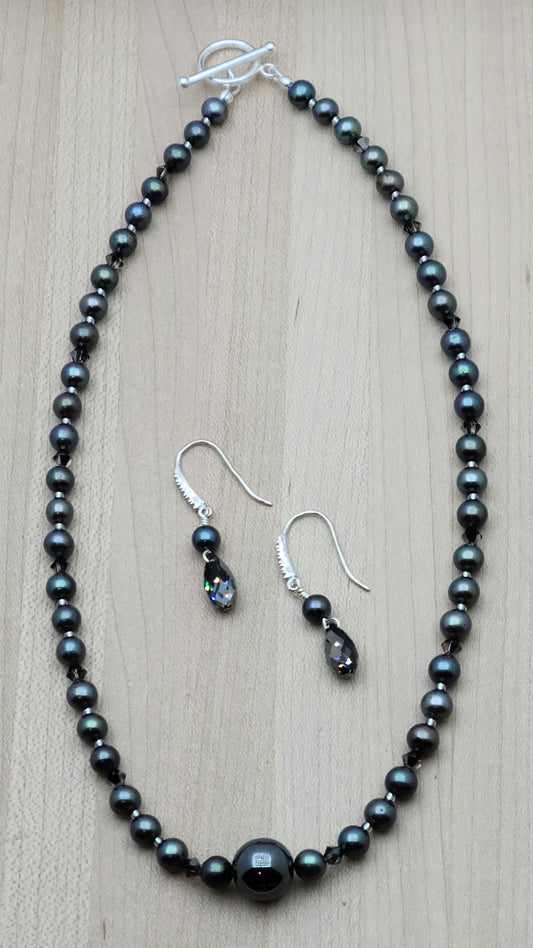 With a dark bluish grey cast, these black freshwater pearls look great with the single, large shiny grey hematite statement bead and silver night crystals!