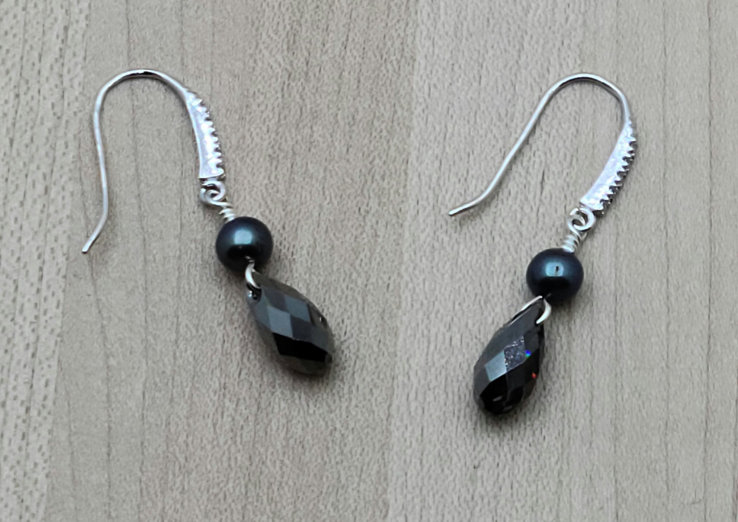 With a dark bluish grey cast, these black freshwater pearls look great with  silver night crystals in these earrings!