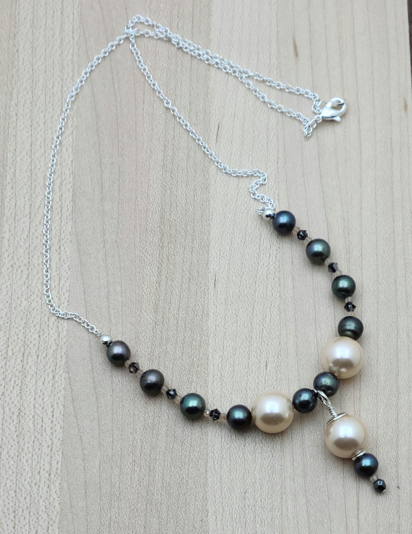 Peach shell pearls show front & center against black FW pearls & crystals in this minimal set.