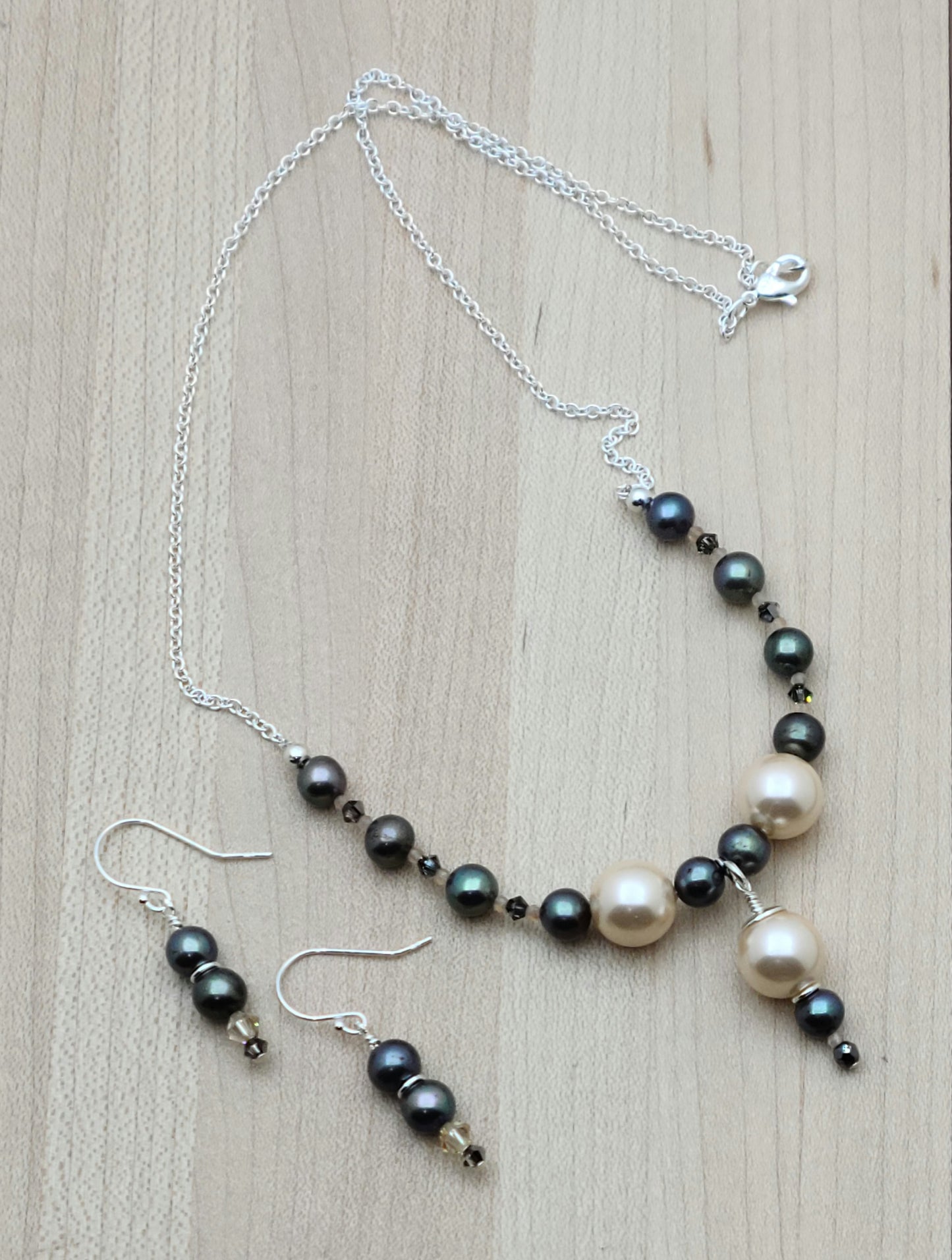 Peach shell pearls show front & center against black FW pearls & crystals in this minimal set.