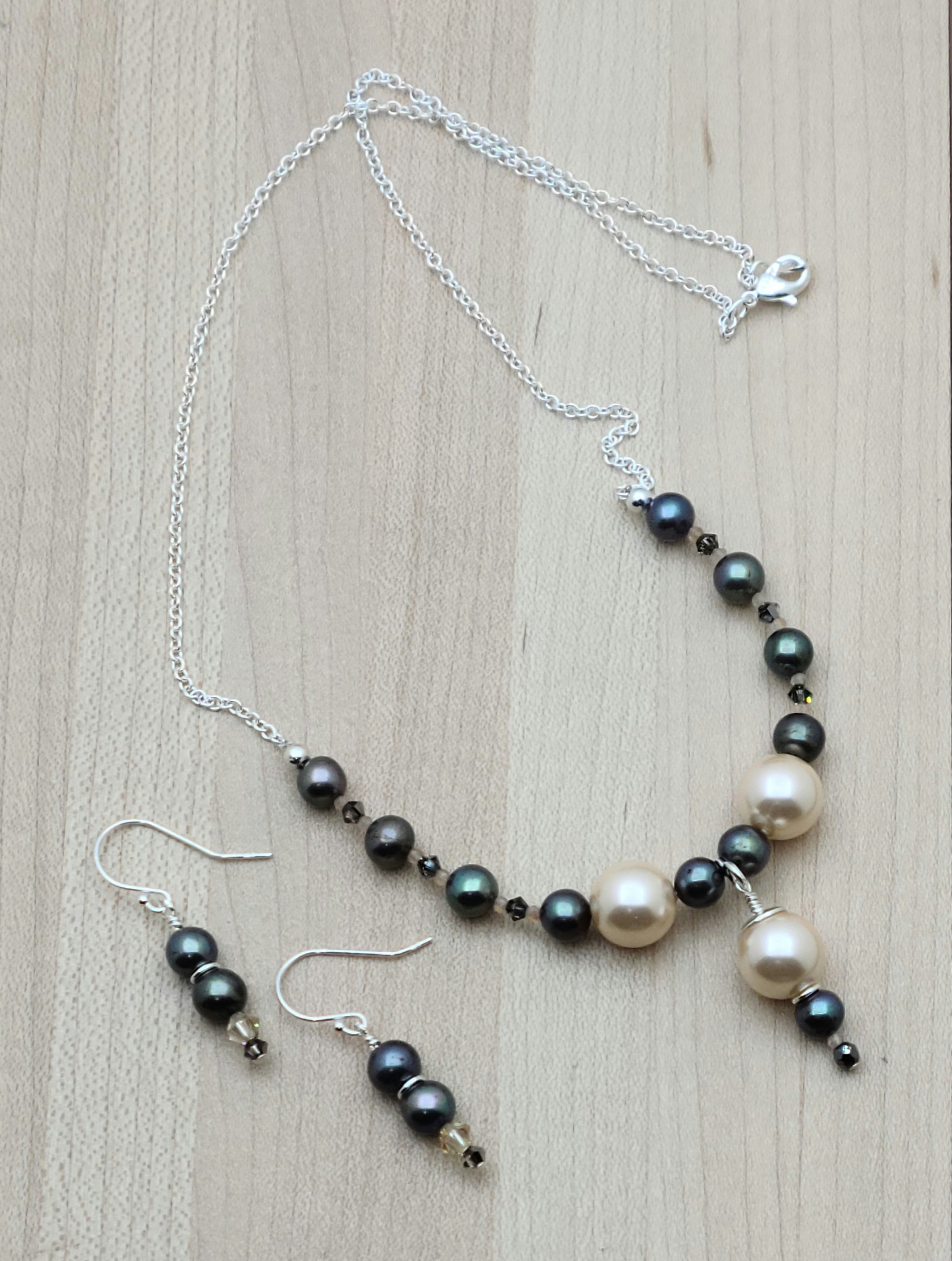 Peach shell pearls show front & center against black FW pearls & crystals in this minimal set.