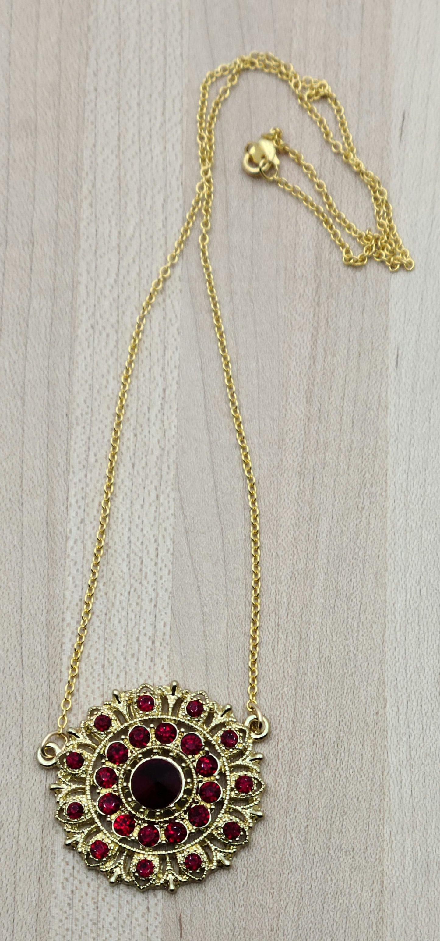 I found a gorgeous gold vintage scarlet crystal* encrusted medallion, added chain and earrings, and voila - a very striking set!