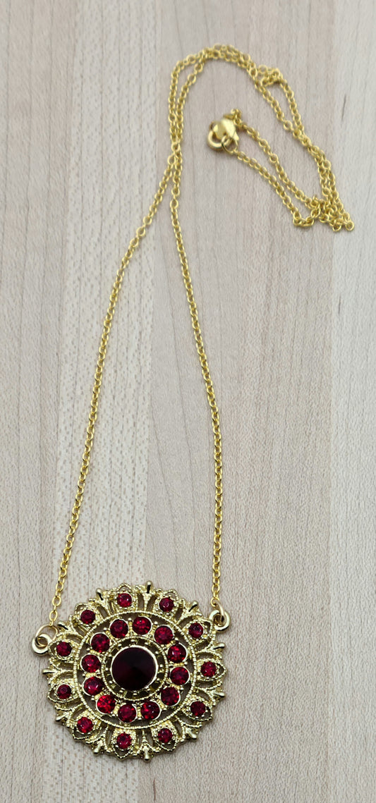 I found a gorgeous gold vintage scarlet crystal* encrusted medallion, added chain and earrings, and voila - a very striking set!