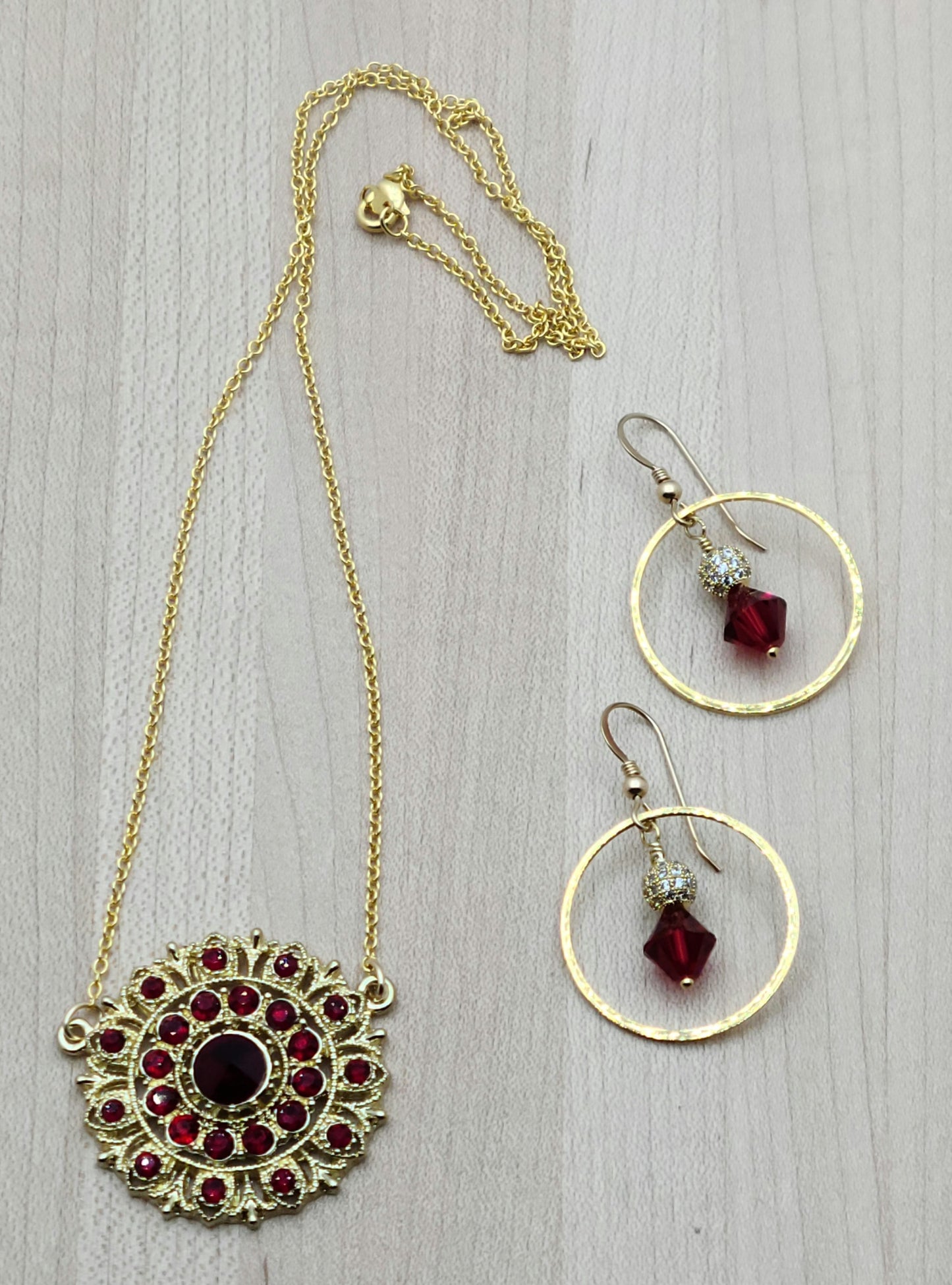 I found a gorgeous gold vintage scarlet crystal encrusted medallion, added chain and earrings, and voila - a very striking set!