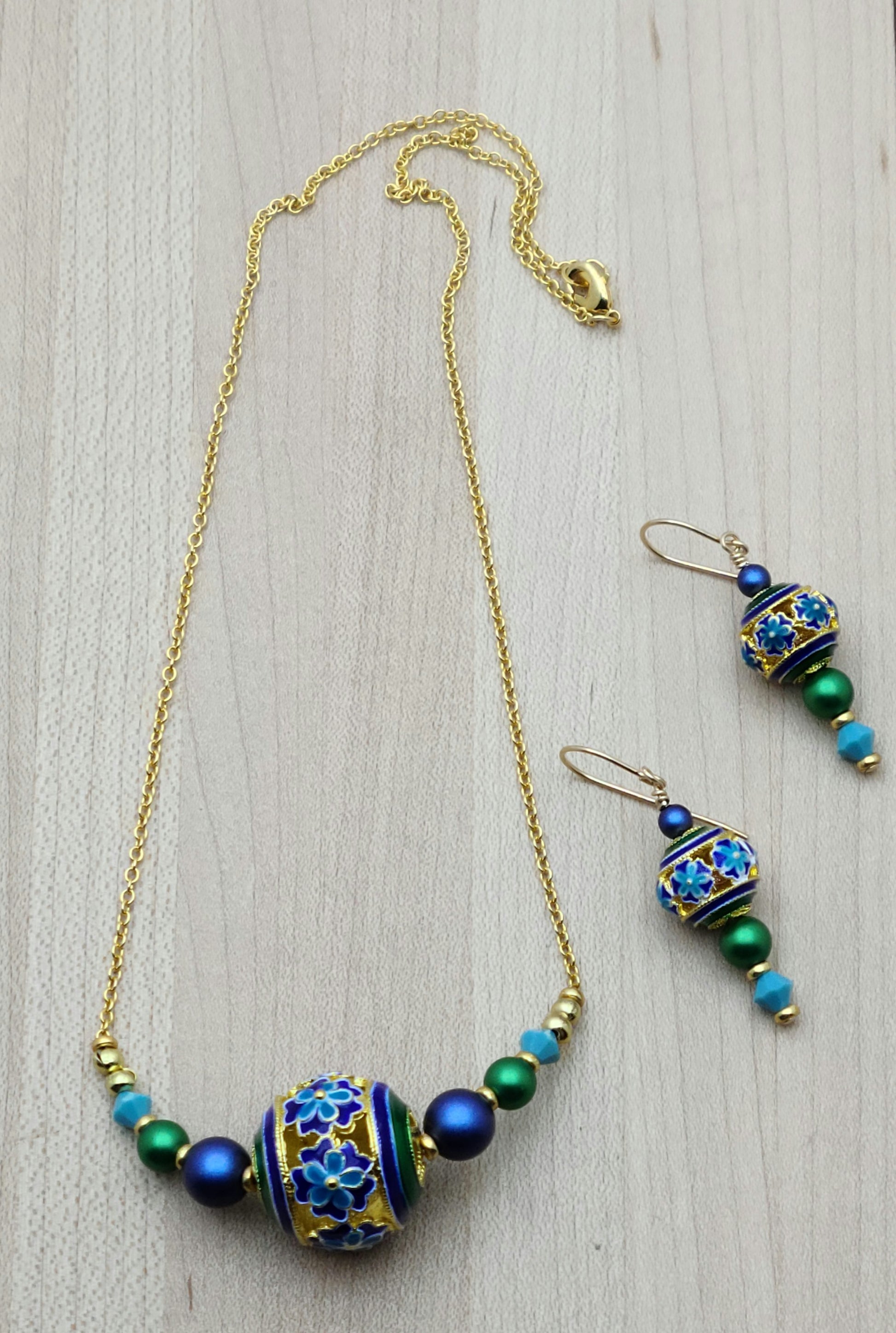 You'll smile every time you wear these vividly colored cloisonne beads of turquoise, blue, green, & gold! I've added equally bright & complimentary colors of crystal pearls and crystals for a lovely set.