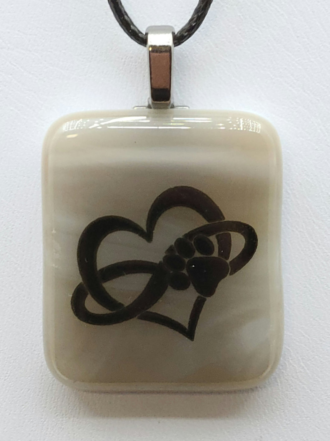 Celebrate your love for your furry friend with this unique Heart Paw fused glass pendant.