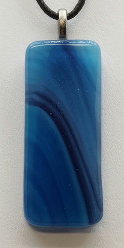 Add a pop of color to any outfit with our Blue Streaked Column Fused Glass Pendant.