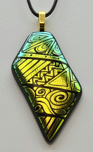 Expertly crafted from fused glass, the On Point pendant features bold geometrics etched in vibrant gold dichroic glass.