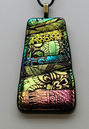 This Persian Carpet Fused Glass Pendant boasts a captivating design, created from an array of etched dichroic glass strips. 