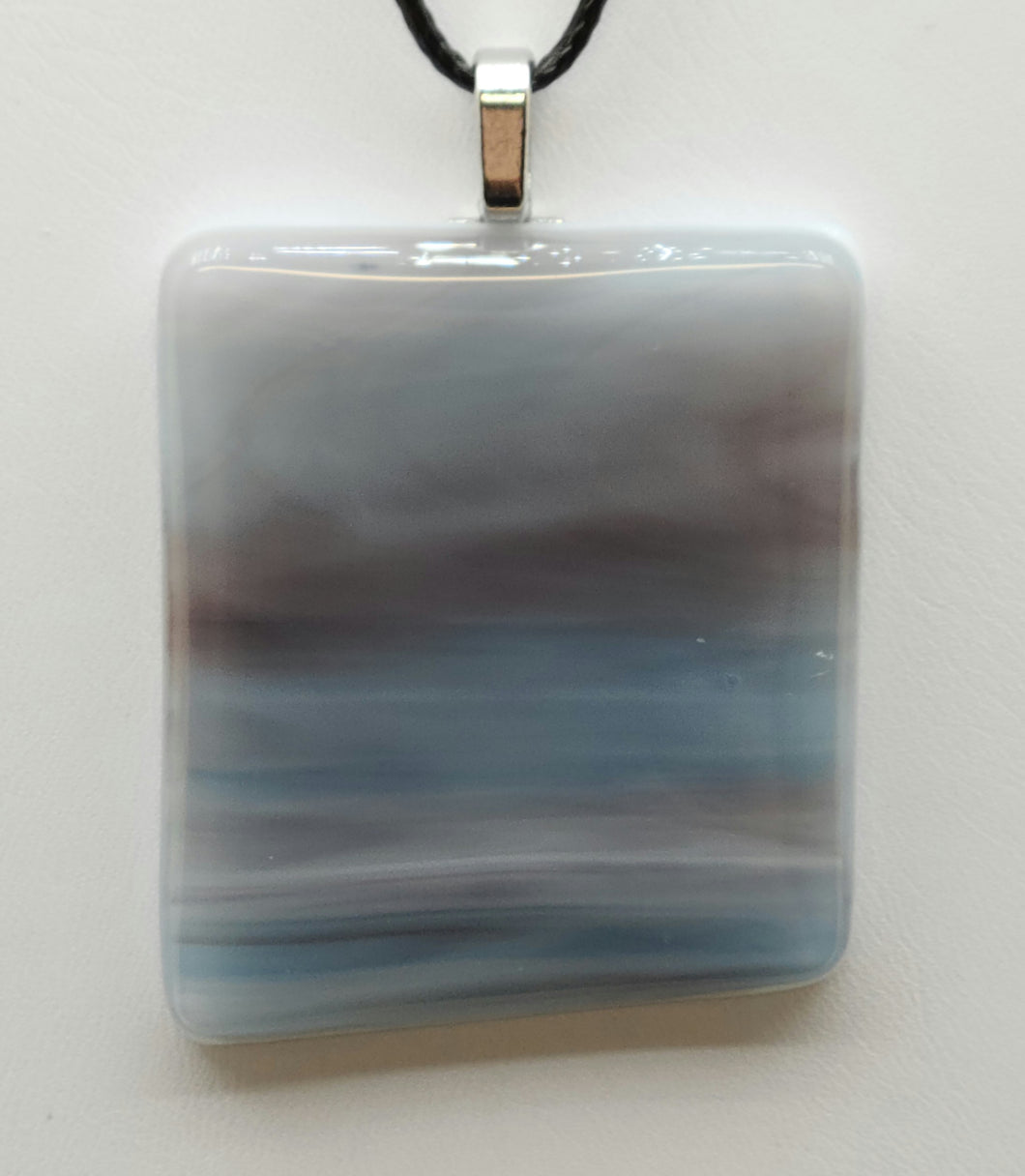 Mesmerize yourself with the Sky & Clouds Fused Glass Pendant.