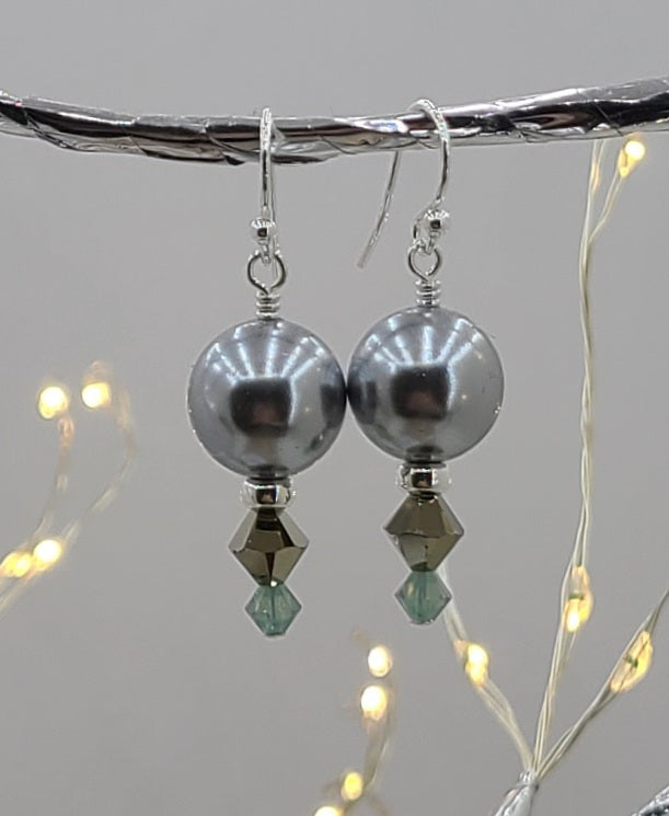 Earrings of Lovely, large, shiny silver shell pearls complimented by crystals* and sterling silver.