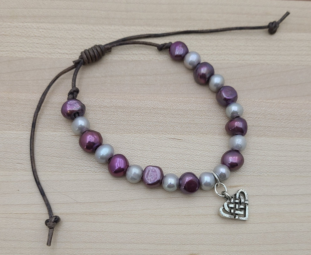 You'll love these beautiful purple & silver freshwater pearls hosting a lead free pewter Celtic knot in the shape of a heart!