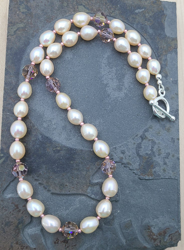The high quality freshwater pearls are a lovely, soft pink and are paired with light amethyst champagne crystals* and finished off with Miyuki seed beads & sterling silver! 