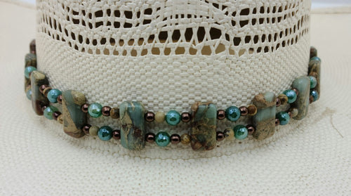  This hatband combines aqua terra jasper, green electroplated sardonyx, rose gold plated hematite, & leather! Adjustable by a leather slider knot.