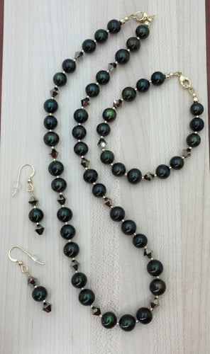 Very nice deep green pearls, aurum (latin for gold) crystals, champagne Miyuki delica, & gold filled findings necklace, bracelet, earrings