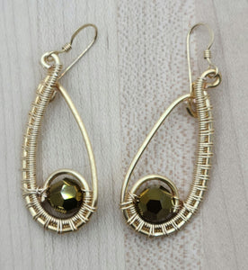 Lovely deep gold crystals are nestled in the curve of these gold colored woven wire teardrop earrings.
