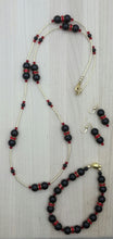 The bold colors of black & red are celebrated in this necklace, bracelet, & earring set of black crystal pearls* & bright red crystal* rondelles spaced by liquid gold!