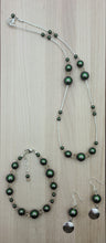 Iridescence is the highlight of this necklace, bracelet, earring jewelry set of scarab green crystal pearls & delicate light silk crystals spaced by liquid silver!