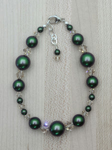 Iridescence is the highlight of this bracelet of scarab green crystal pearls & delicate light silk crystals