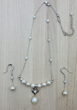 A cubic zirconia adorned heart hosts a white teardrop freshwater pearl and the drop hangs from more FW pearls & CZ embellished chain in this delicate set of pearl jewelry.