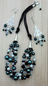 Tahitian blue & dove grey.  A stunning 4 strand braid of crystals*, crystal pearls*, freshwater pearls, onyx, & Miyuki seed beads finished off with sterling silver & rattail satin. Chandelier earrings.