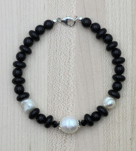 Black onyx & large white baroque freshwater pearls make a stunning contrast in this bracelet