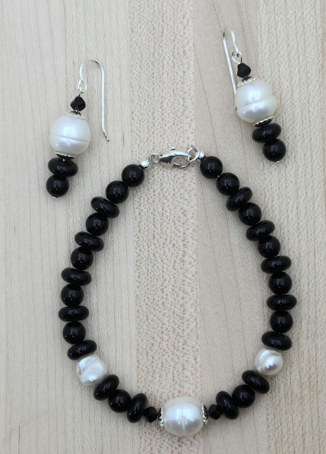 Black onyx & large white baroque freshwater pearls make a stunning contrast in this bracelet & earring duo.